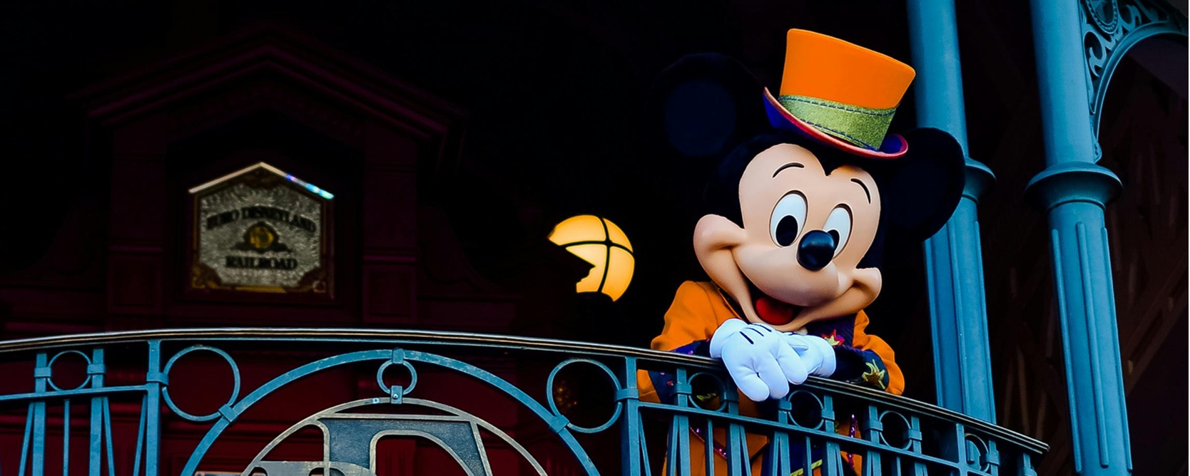 mage-of-mickey-mouse-on-balcony-at-Disneyland-Paris-to-accompany-article-by-vxtream-on-AI-in-2025-specifcally-Disney-and-OpenAI-content-licensing-deal.