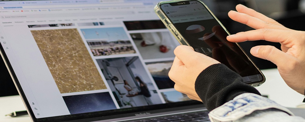 image-of-person-using-both-mobile-phone-and-laptop-simultaneously-to-accompany-article-on-demand-for-more-data-centre-capacity